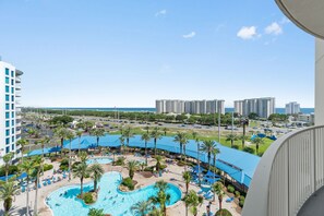 A hotel with a pool, palm trees, and a view of the ocean. - 2815 Gorgeous Gulf Views ~ Pools ~ Bar ~ Gym ~ Pickleball & More ~ Book Oct 26th (Destin)