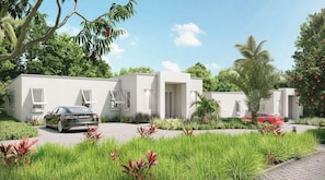 Uma área residencial moderna com casas brancas, um caminho de paralelepípedos e carros estacionados na frente.