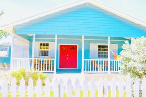 A house with a blue exterior, a red door, and a white picket fence. - Endless Summer - by Zenbreak (Inch Marlowe)