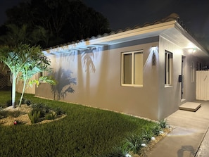 A single-story house with a small porch, a well-maintained lawn, and a tree. - Private Pool + Mini Golf | Near Hollywood Beach (Hollywood)