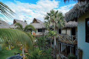 A resort with thatched-roof buildings, a wooden deck, and tropical vegetation. - VENTURA BARRA GRANDE (Cajueiro da Praia)