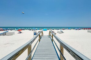 A wooden boardwalk leading to a beach with umbrellas and beach chairs. - Perdido Sun 216 | 4 Bdrm Corner Condo | Beachfront | Pools | Walk Everywhere | My Beach Getaways (Pensacola)