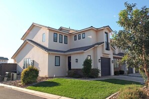 A two-story house with a sloped roof, a front garage, and a well-maintained lawn. - Athlete's Retreat | Pool, Hot Tub, Pet Friendly (Washington)