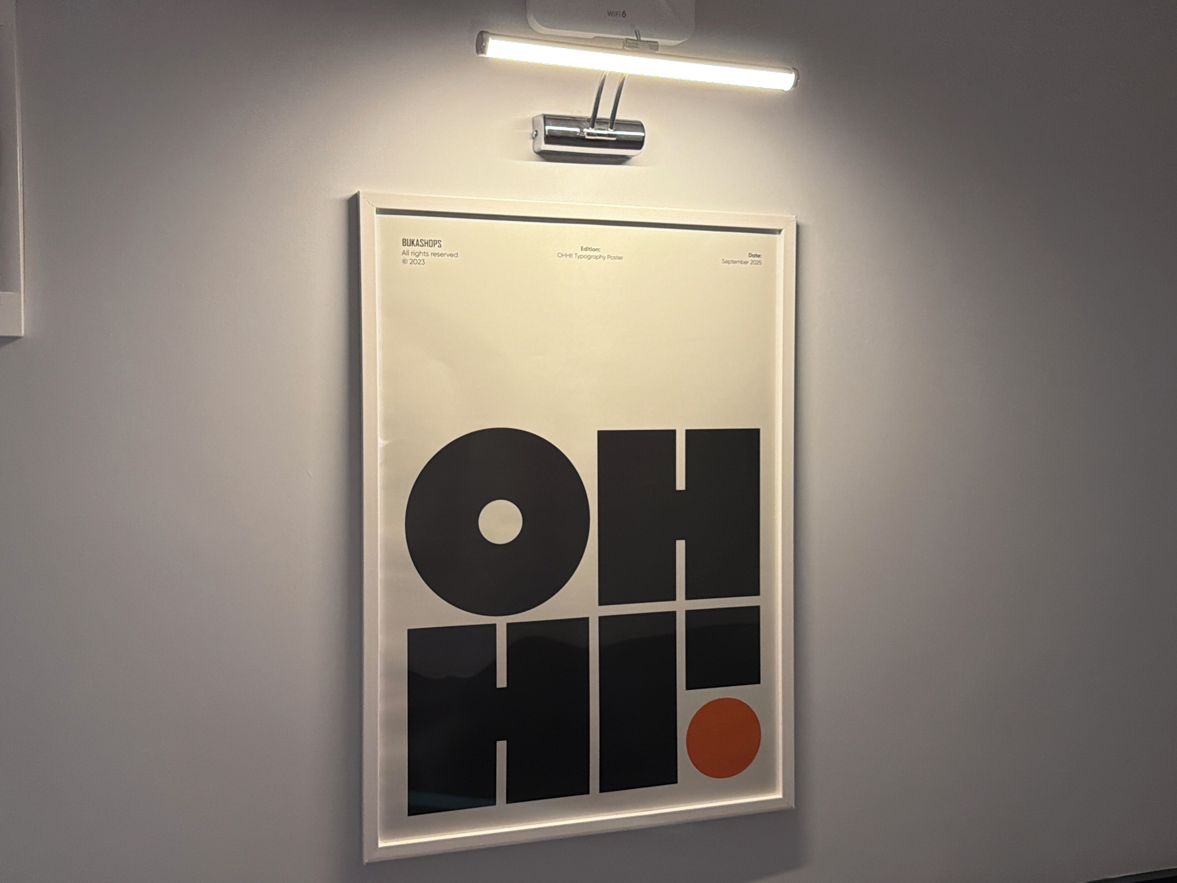 A framed poster with the text 'BUKASHOPS' and 'Edition' on a wall.
