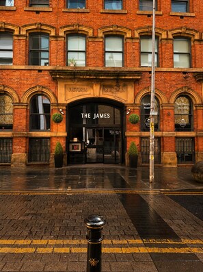 A Victorian-style building with 'The James' sign, brick facade, and arched windows. - Modern 2BR • Workspace • City Centre • 3 Beds (Manchester)