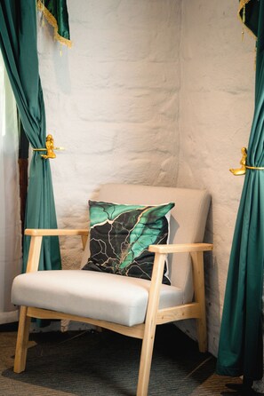 A corner room with a wooden chair, a cushion, and green curtains. - Little Acorn - Sun-Kissed Forest Garden, Emerald (Emerald)
