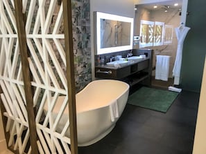 A modern bathroom with a freestanding bathtub, dual sinks, and a large mirror. - Your Own Slice of Paradise — Space for Everyone, Privacy for All (Cancún)