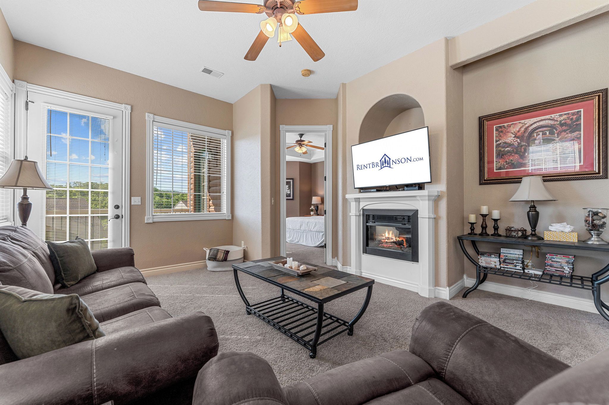 A living room with a fireplace, a television, and a sofa.