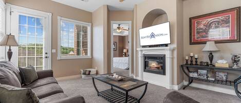 A living room with a fireplace, a television, and a sofa.