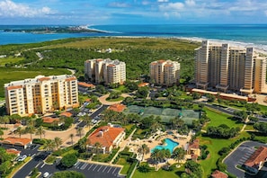 A high-rise hotel complex with multiple buildings, a central courtyard, and a swimming pool. - Serene Saltwater Sanctuary | Inlet #607 (New Smyrna Beach)