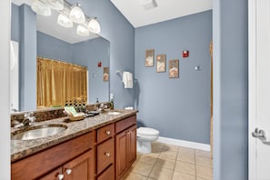 A bathroom with a double sink vanity, a toilet, and a large mirror. - Venus 142 2 Bedroom Condo (Gatlinburg)