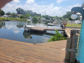 A calm water body with a dock and a boat. -  2-bed house with central AC in charming Hudson canal to gulf in minutes. (Hudson)