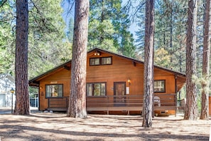 A wooden cabin with a porch, surrounded by tall trees. - (42A) Megan's Retreat at The Redwoods in Yosemite (Yosemite National Park)
