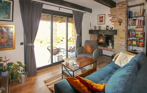 Ein Wohnzimmer mit einer Couch, einem Couchtisch, einem Kamin und einem Bücherregal.