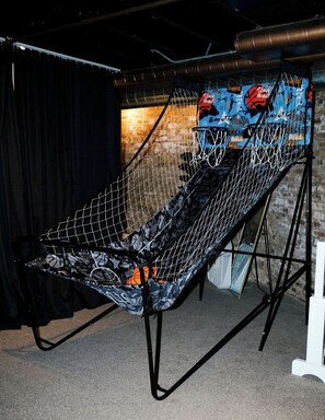 A basketball hoop with a net, set up indoors with a brick wall background. - 4 BR • Theater Room • Gym • Walk to Lincoln Park! (Chicago)