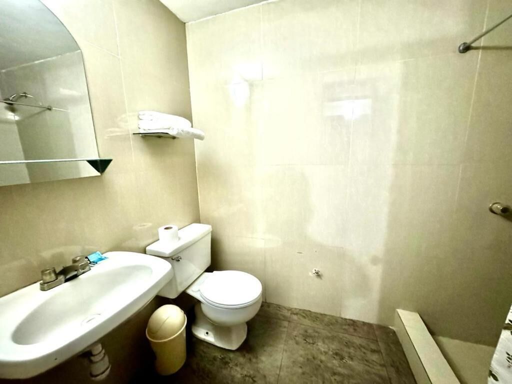 A bathroom with a sink, toilet, and bathtub.