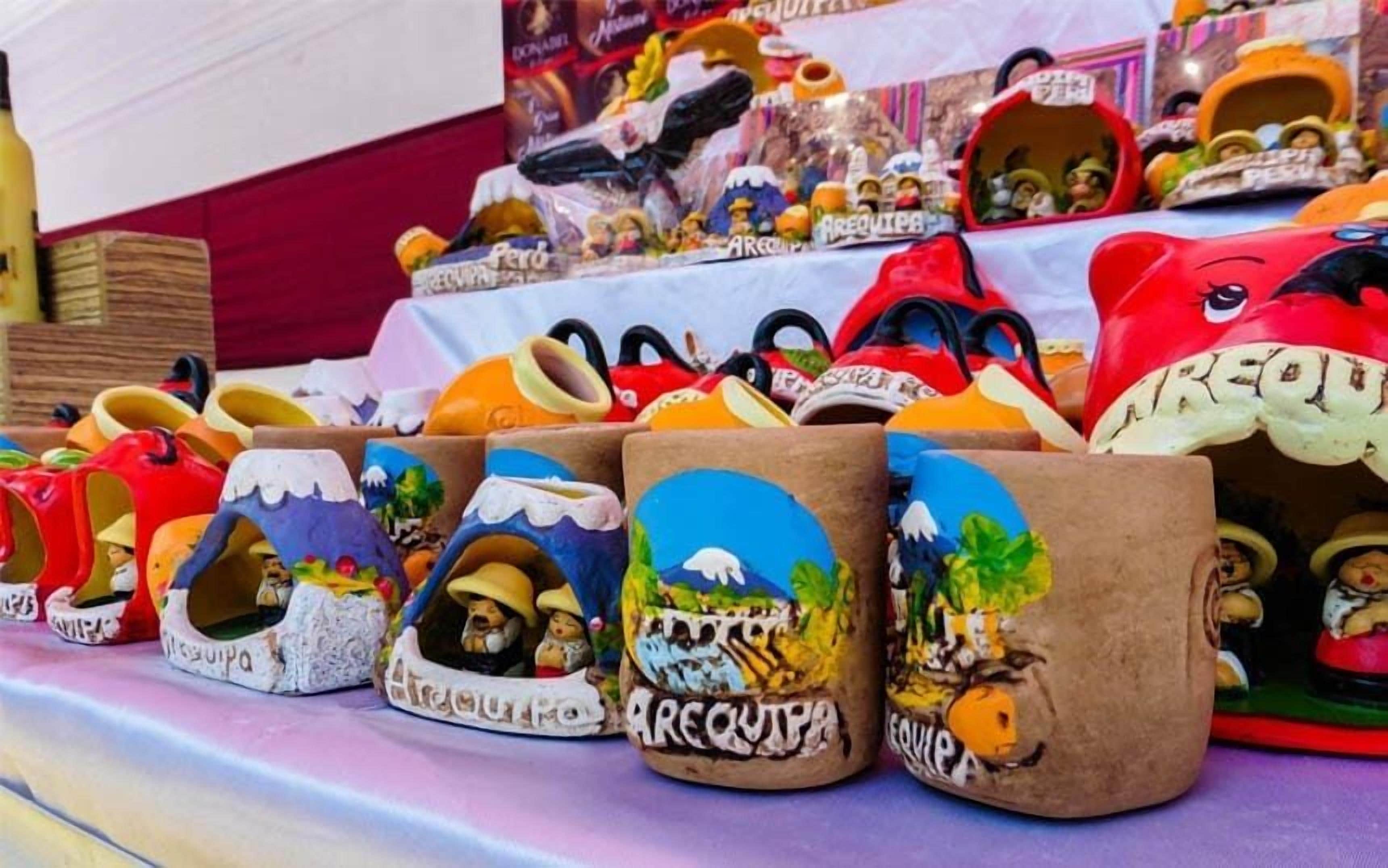 A display of colorful ceramic mugs with various designs.