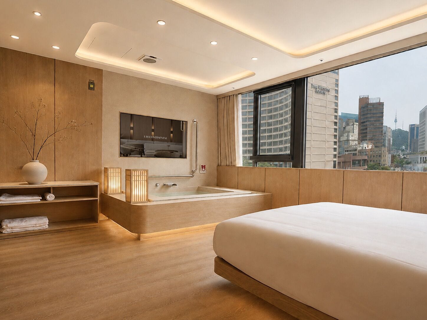A modern bedroom with a large bed, a bathtub, and a city view.