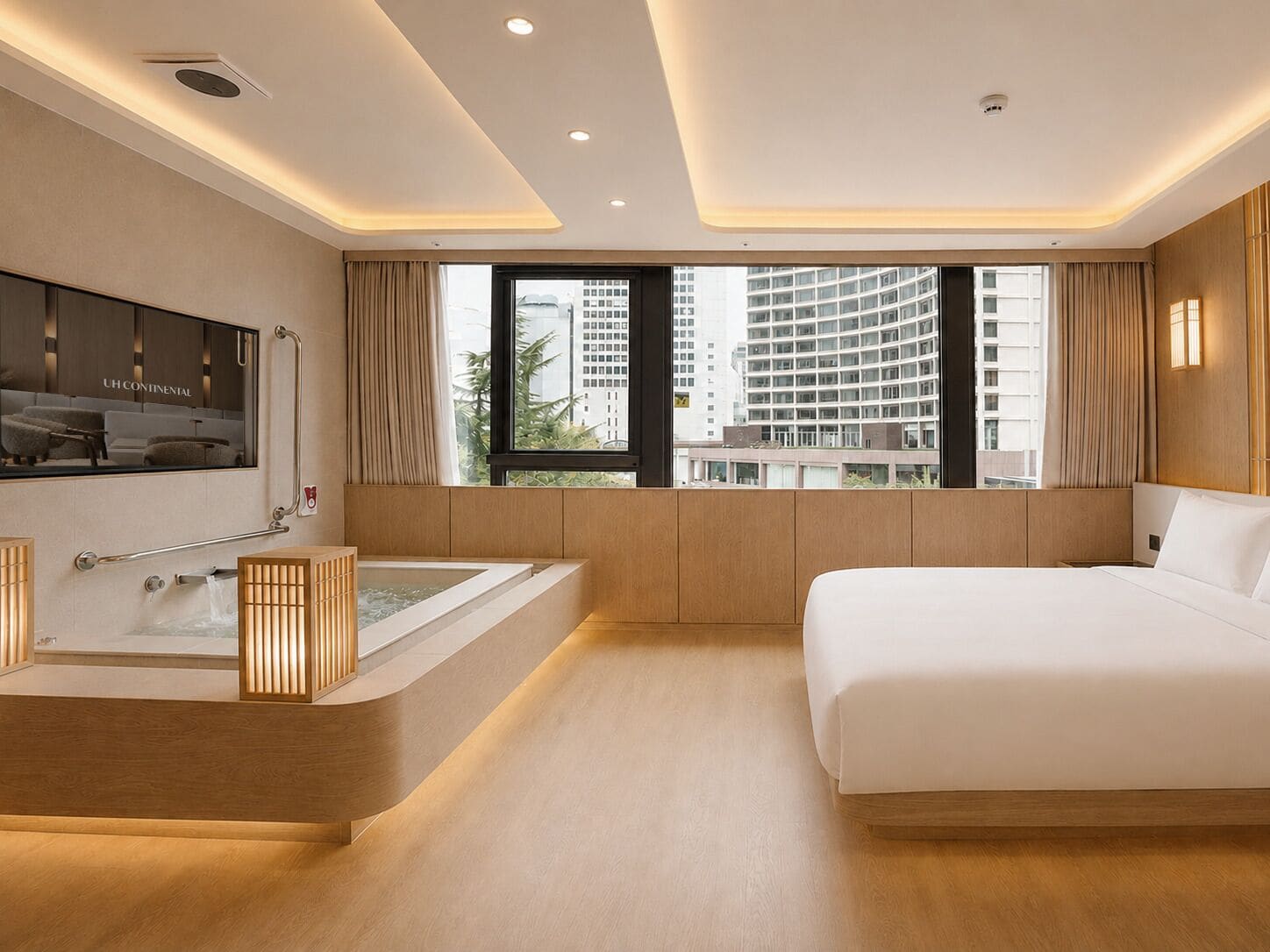 A modern hotel room with a large bed, a bathtub, and a view of tall buildings.