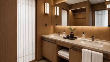 Un baño moderno con muebles de madera, un lavamanos doble y un espejo grande.