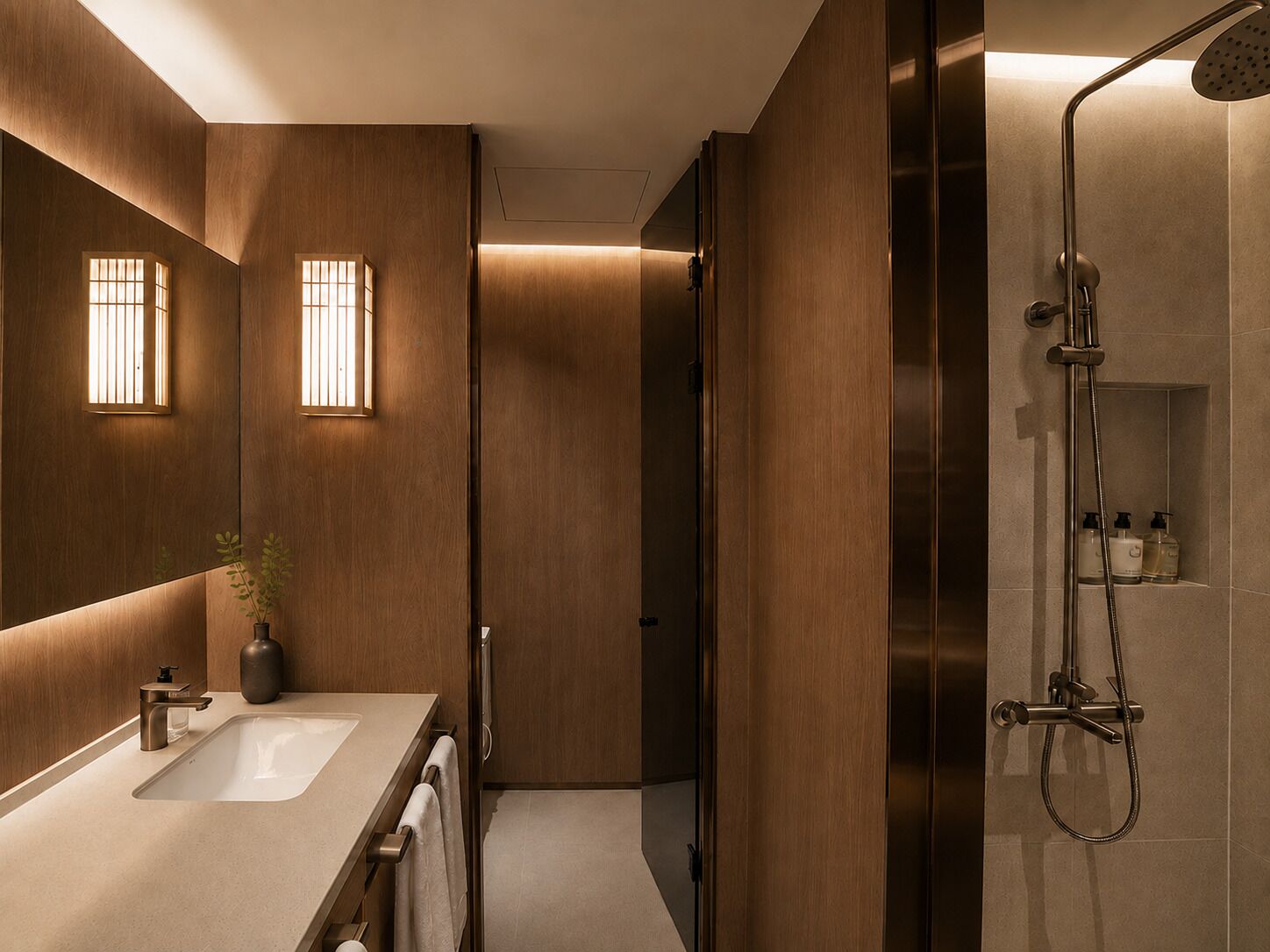 A modern bathroom with a large mirror, two sinks, a shower, and a potted plant.