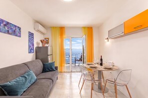 A modern apartment with a balcony, a dining area, and a living room. - Beachside Villa Mia Apartment 2, Medveja, Croatia (Medveja)