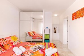 A bedroom with a bed, a wardrobe, a small desk, and a door leading to another room. - Beachside Villa Mia Apartment 2, Medveja, Croatia (Medveja)