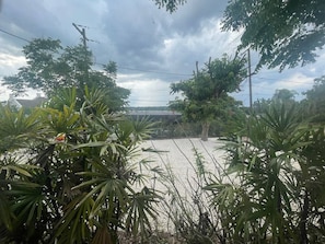 A view of a road with a bridge, surrounded by dense vegetation and power lines. - Hotel Style Lakeview Cottage • 3BR • Heated Pool (Lake Wales)