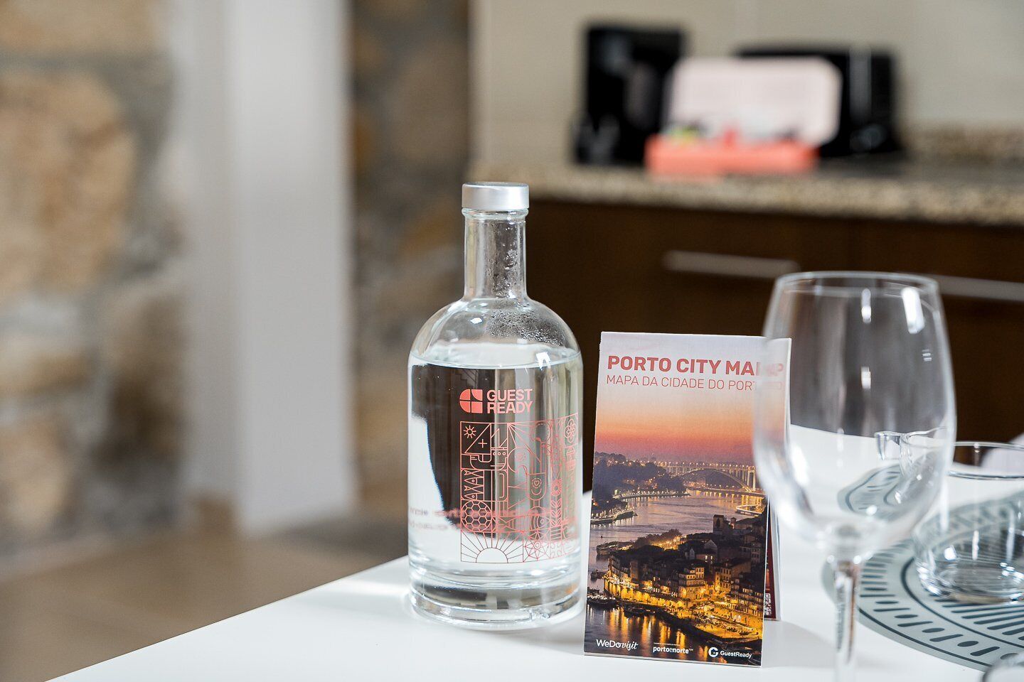 A bottle of water, a glass, and a printed map on a table.