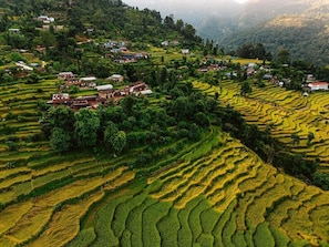 Terraced fields with houses and a valley. - Barang Village Community Homestay  (Pokhara)