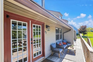 A covered porch with a seating area, a wooden deck, and a view of the surrounding landscape. - CanaanValley Views! FirePit - Arcade - ResortAmenities (Davis)