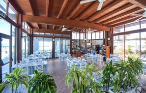 An indoor dining area with tables and chairs, wooden beams, and large windows. - Nice home in Torino di Sangro with WiFi (Torino di Sangro)