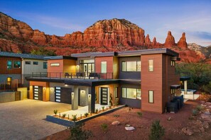 A modern multi-story house with a flat roof, large windows, and a balcony. - Luma Ridge - `26 Luxury Build, Pool & Spa, Views (Sedona)