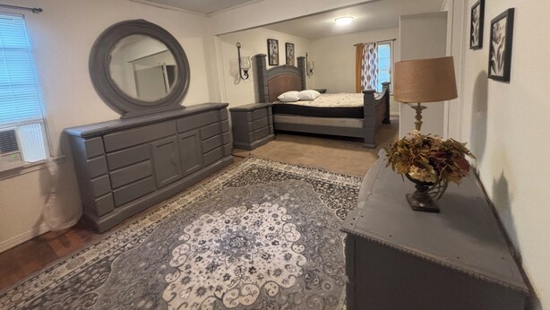 A bedroom with a bed, dresser, mirror, and a rug. - Vintage- Getaway Fabulous 3-bedroom house with AC in charming Columbus (Columbus)