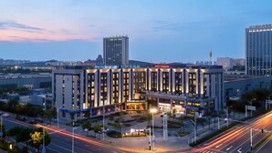 A modern hotel with a central courtyard, multiple floors, and a prominent entrance. - Wanda Moments Bengbu south Railway (Bengbu)