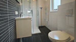 A bathroom with a shower, toilet, and sink. - Holiday Home in Kaatsheuvel With Terrace (Kaatsheuvel)