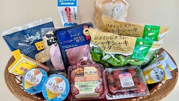 A variety of packaged food items including a carton of milk, a package of crushed cheese, a package of ham, a package of lettuce, and several containers of pickled vegetables.