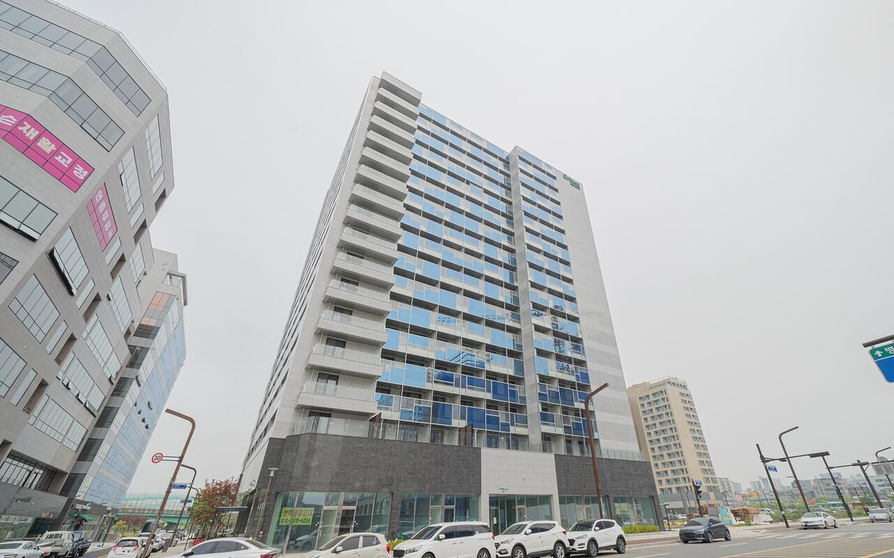 A tall, modern building with multiple floors and large windows.