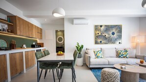 A modern living space with a dining area, kitchen, and seating area. - Hillside Villa with Private Pool & Panoramic Views | Plakias & Preveli (Asomatos)