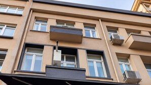 A multi-story building with balconies, large windows, and a red garage door. - ROZA TAKSIM  (Istanbul)
