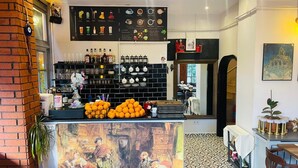A bar area with a menu board, bottles, glasses, and a painting on the wall. - ROZA TAKSIM  (Istanbul)