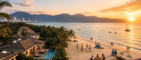A resort with a swimming pool, beach, and ocean views.