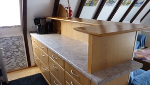 A kitchen with a wooden countertop, a coffee machine, and a vase. - Föhr Vacation Home 11, 88 sqm with 3 bedrooms (Siegsdorf)