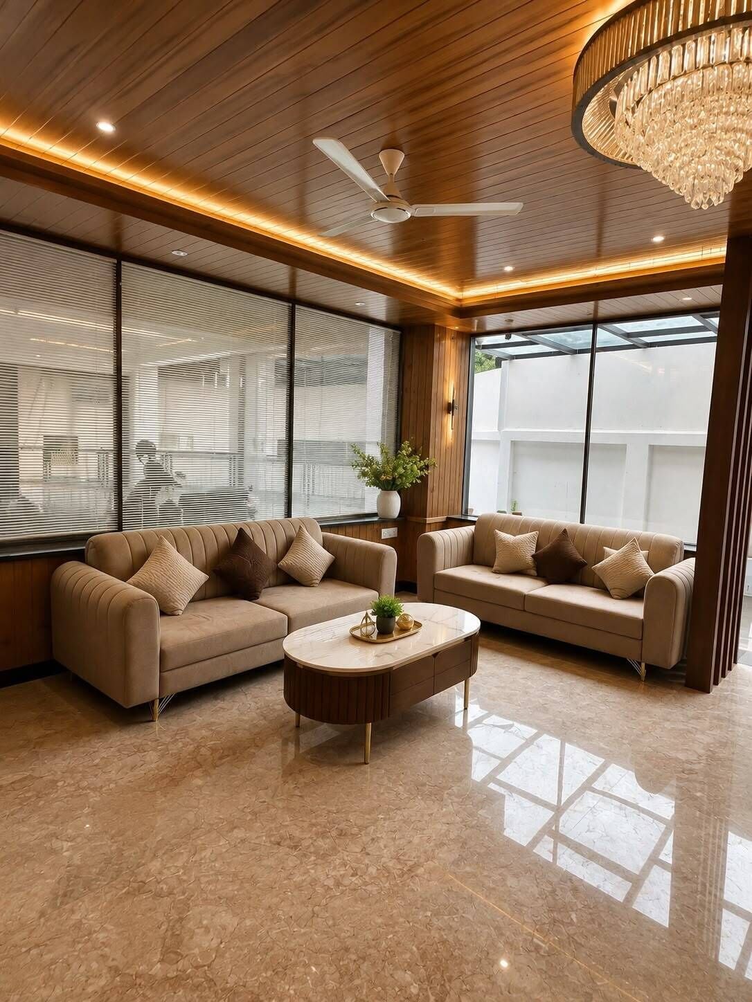 A modern living room with two sofas, a coffee table, and a ceiling fan.