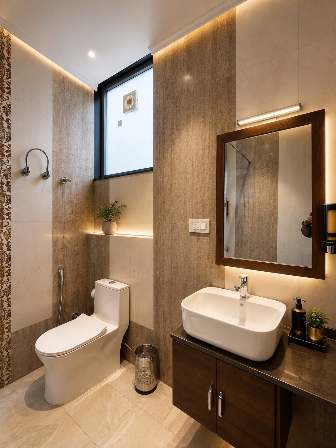 A modern bathroom with a toilet, bidet, sink, and mirror.