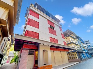 A hotel with a modern facade, multiple balconies, and a clear sky. - Saver Double Plaza Delux (Kanayannur)