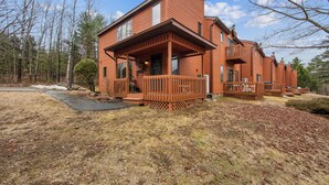 A two-story log cabin with a porch, a chimney, and a small deck. - 2 Homes | Heated Pool + Game Room + Sauna | Mins to Gore Mountain (North Creek)
