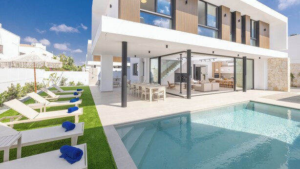 A modern two-story house with a swimming pool, outdoor seating, and a kitchen area. - New 4 Bedroom Villa With Pool, 100 Meters From the Beach (Paralimni)