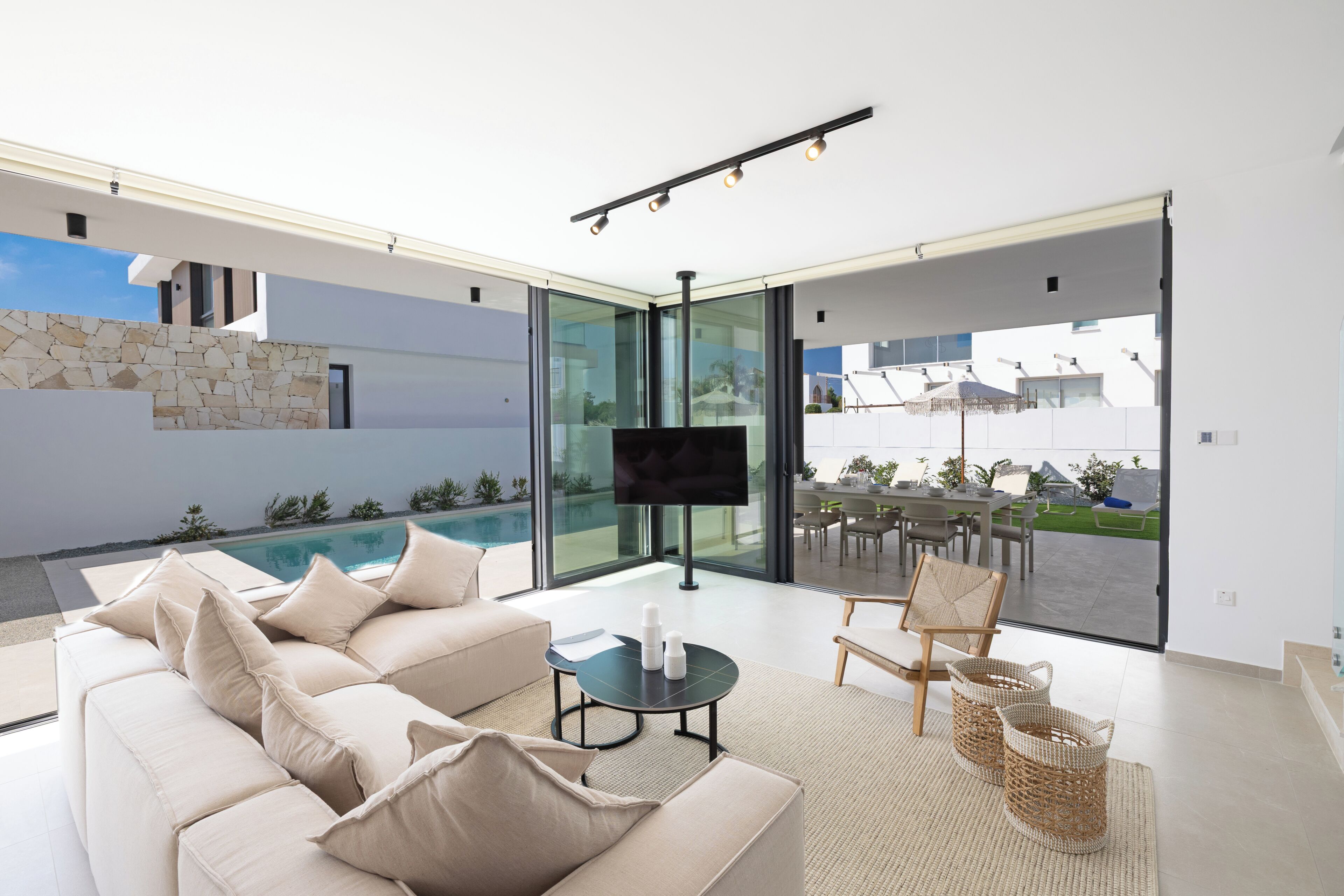 A modern living room with a sofa, a coffee table, and a TV.