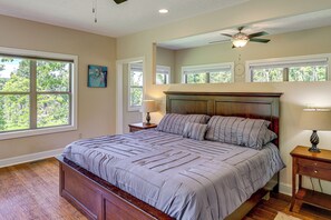 A bedroom with a large bed, a ceiling fan, and multiple windows. - Asheville Mountain Hideaway, 6 Mi to Dtwn (Asheville)